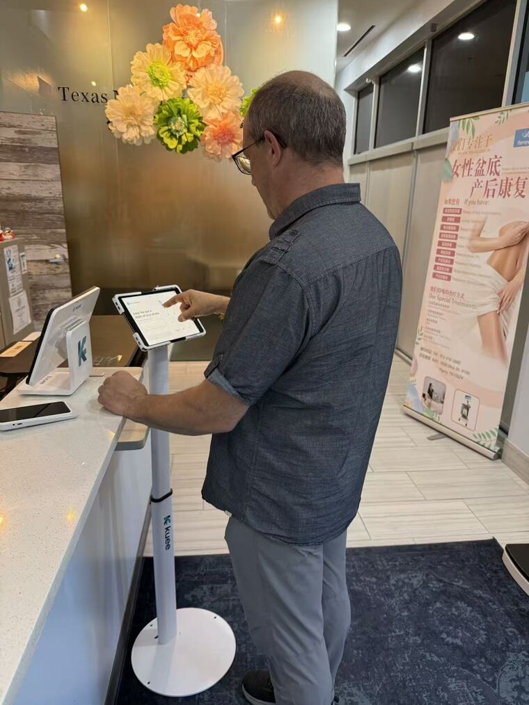 A patient using the self check-in station at ACT Therapy Clinic