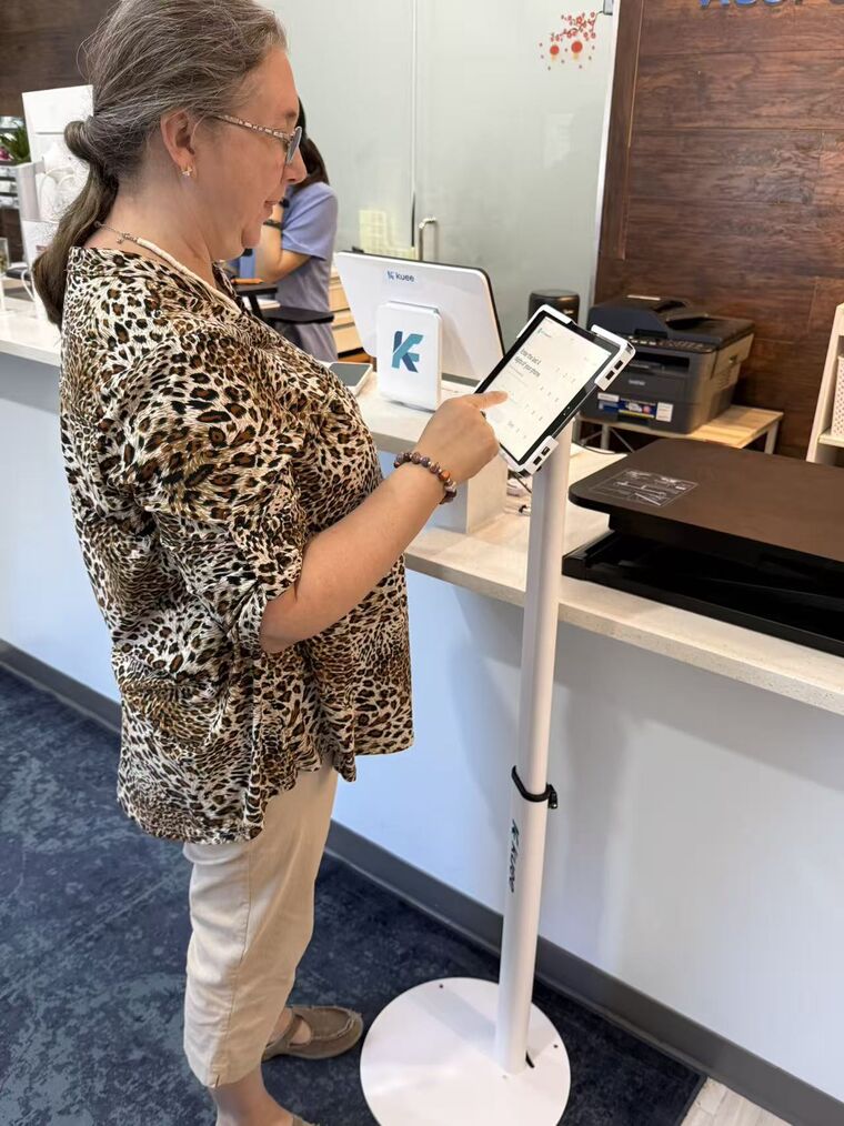 A patient checking in at the clinic front desk